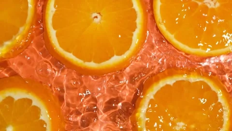Refreshing citrus background with water moving over bright orange slices Stock Footage 344952900