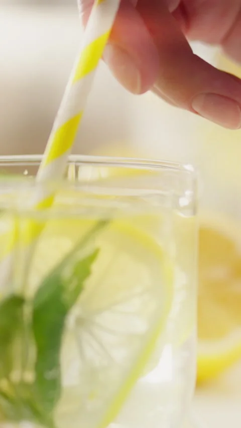 A refreshing citrus beverage with mint and lemon served in a glass with a st Stock Footage 331529678