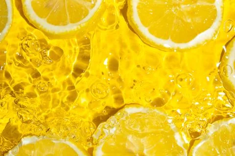 Refreshing citrus composition with sliced lemons floating in transparent wate 写真素材