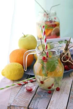 Refreshing cocktail, detox water from organic fruits and berries, mint leaves Stock Photos