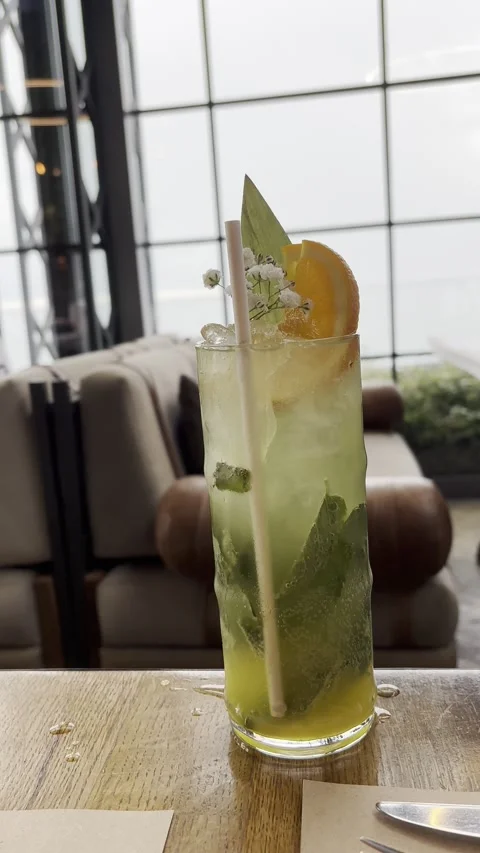 Refreshing cocktail in elegant glass at seaside cafe Stock Footage 339733078