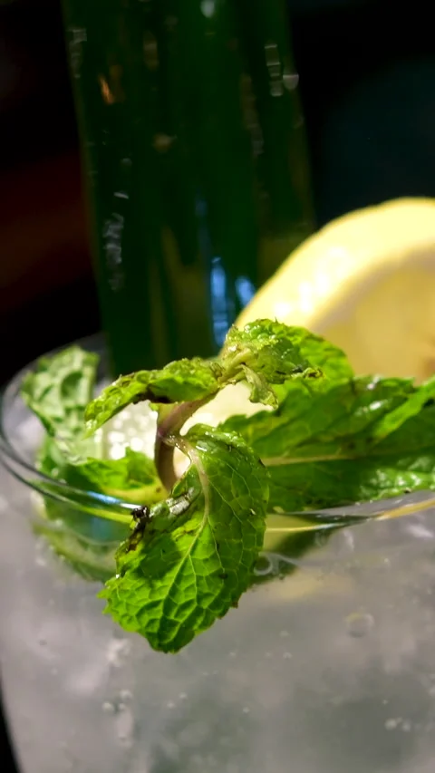 Refreshing cocktail garnish sequence of pouring blue cocktail into a glass with Stock Footage 313686035