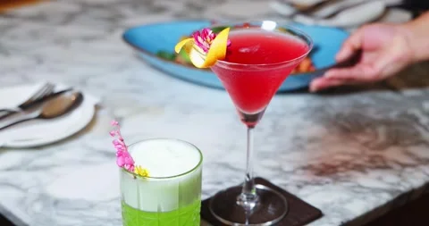 Refreshing cocktails on marble table at upscale restaurant, featuring Stock Footage 318117419