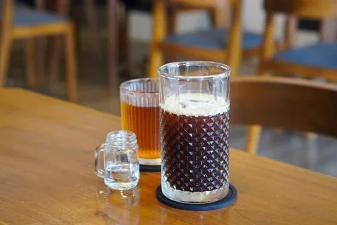 A refreshing coffee drink made by combining rich espresso with cold water Stock Photos