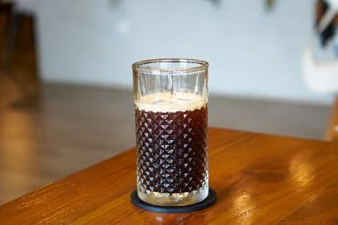 A refreshing coffee drink made by combining rich espresso with cold water Stock Photos