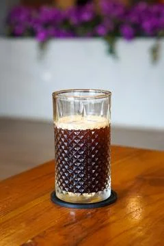 A refreshing coffee drink made by combining rich espresso with cold water Stock Photos