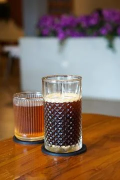 A refreshing coffee drink made by combining rich espresso with cold water Stock Photos