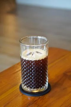 A refreshing coffee drink made by combining rich espresso with cold water Stock Photos