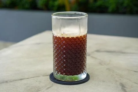 A refreshing coffee drink made by combining rich espresso with cold water Stock Photos