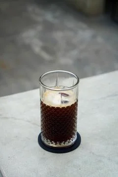 A refreshing coffee drink made by combining rich espresso with cold water Stock Photos