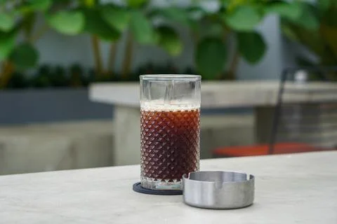 A refreshing coffee drink made by combining rich espresso with cold water Stock Photos
