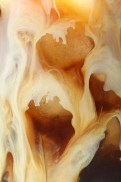 Refreshing coffee with ice and milk as background, closeup Stock Photos