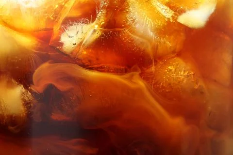 Refreshing coffee with ice and milk as background, closeup 写真素材