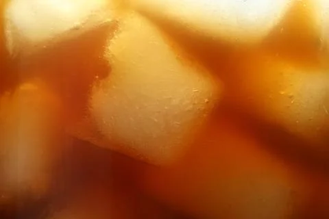 Refreshing coffee with ice cubes as background, closeup 스톡 사진