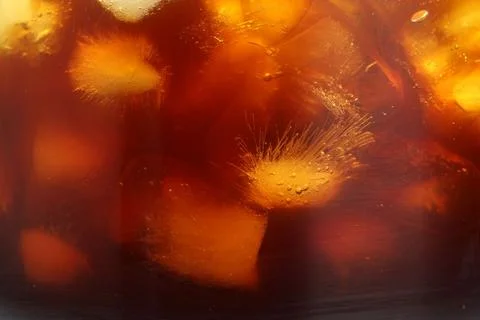 Refreshing coffee with ice cubes as background, closeup Stock Photos