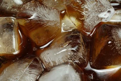 Refreshing coffee with ice cubes as background, above view Foto stock