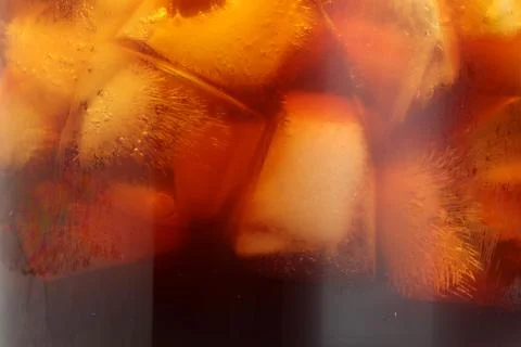 Refreshing coffee with ice cubes as background, closeup 스톡 사진