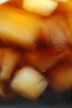 Refreshing coffee with ice cubes as background, closeup Stock Photos