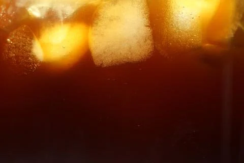 Refreshing coffee with ice cubes as background, closeup Stock Photos