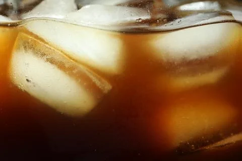 Refreshing coffee with ice cubes as background, closeup 写真素材