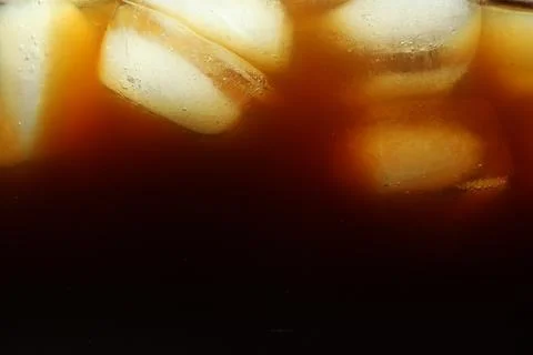 Refreshing coffee with ice cubes as background, closeup Foto stock