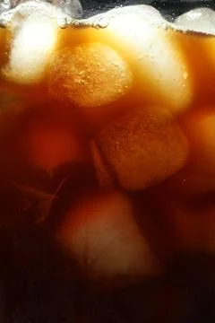 Refreshing coffee with ice cubes as background, closeup Stock Photos