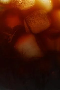 Refreshing coffee with ice cubes as background, closeup Stock Photos