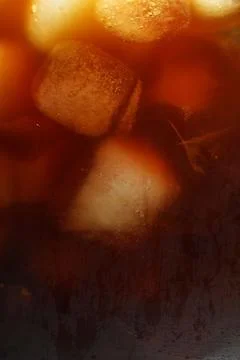 Refreshing coffee with ice cubes as background, closeup Foto stock