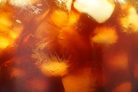 Refreshing coffee with ice cubes as background, closeup Stock Photos