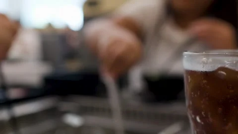 Refreshing Cola Drink on Table at Busy Asian Hot Pot Restaurant Video stock 334698096