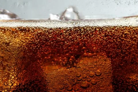 Refreshing cola with ice against light grey background, closeup 写真素材