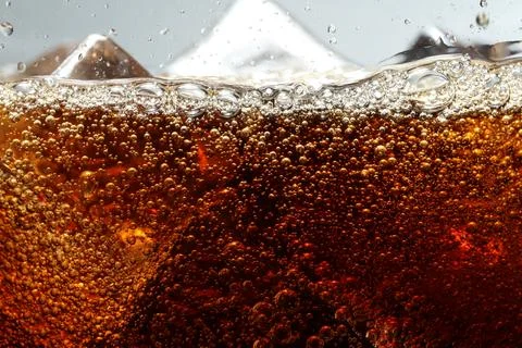 Refreshing cola with ice against light grey background, closeup 스톡 사진