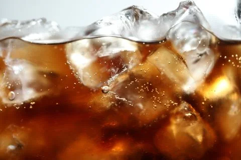 Refreshing cola with ice and bubbles, macro view 写真素材