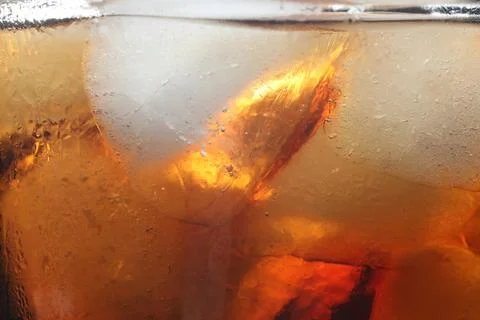 Refreshing cola with ice as background, macro view Foto stock