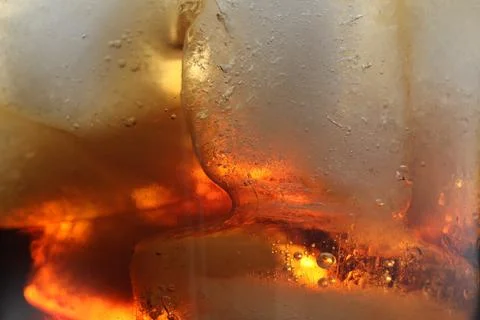 Refreshing cola with ice as background, macro view 写真素材