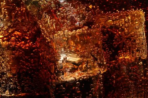 Refreshing cola with ice as background, macro view 写真素材