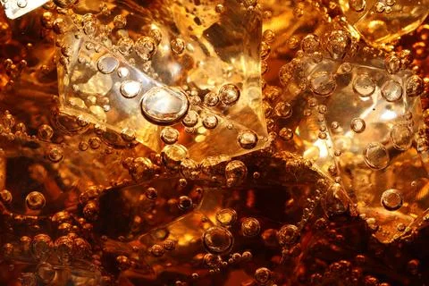 Refreshing cola with ice as background, macro view Foto stock