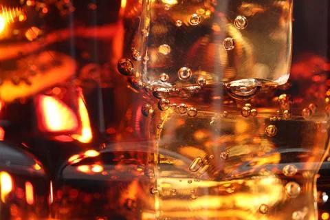 Refreshing cola with ice cubes as background, macro view Stock Photos