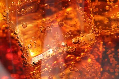Refreshing cola with ice cubes as background, macro view Foto stock