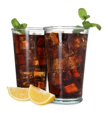 Refreshing cola with mint, ice cubes and slices of lemon in glasses isolate.. Stock Photos