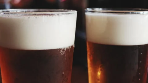 Refreshing cold beer glasses with foamy head Stock Footage 342200047