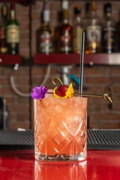 Refreshing cold cocktail with cherry on the bar. Summer party background. 写真素材