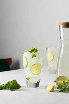 Refreshing cold drink with lime and mint Stock Photos