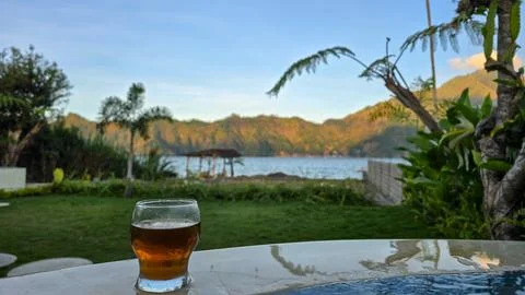 Refreshing Cold Drink on Table with Scenic View of Lake Batur in Kintamani Bali 스톡 사진