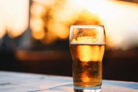Refreshing Cold Glass Of Beer On Table At Sunset Stock Photos