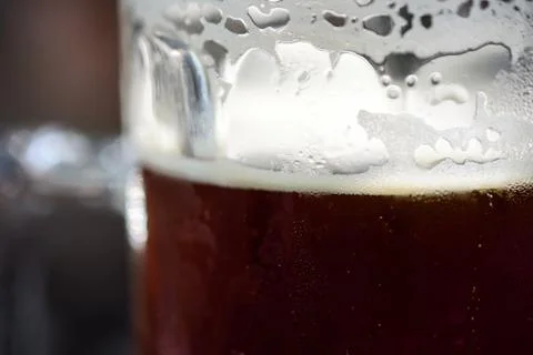 Refreshing Cold Glass Of Dark Beer With Condensation, Foam And Bubbles Stock Photos