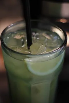 Refreshing cold green lemonade with ice in a glass Stock Photos