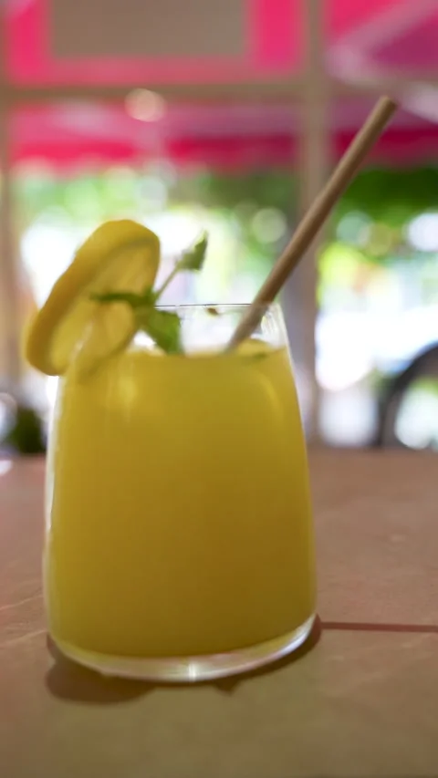 Refreshing cold lemonade with lemon and mint in a modern cafe Stock Footage 340397047