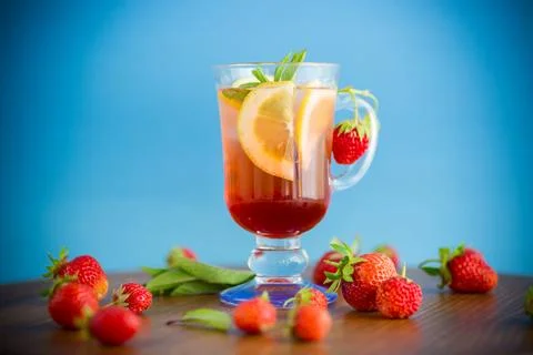 Refreshing cool strawberry lemonade with lemon, ice and mint in a glass Stock Photos