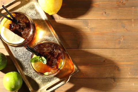Refreshing Cuba libre cocktail with mint on wooden table, flat lay. Space f.. 스톡 사진